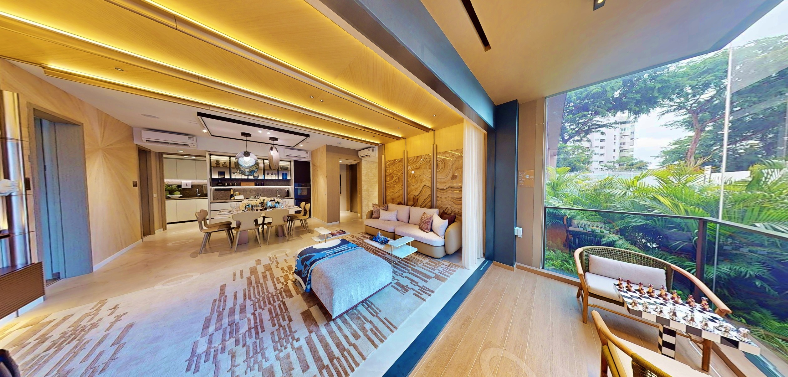 Interior photograph of Nava Grove a modern apartment with dining area, sofa, and balcony featuring outdoor seating and a chessboard.