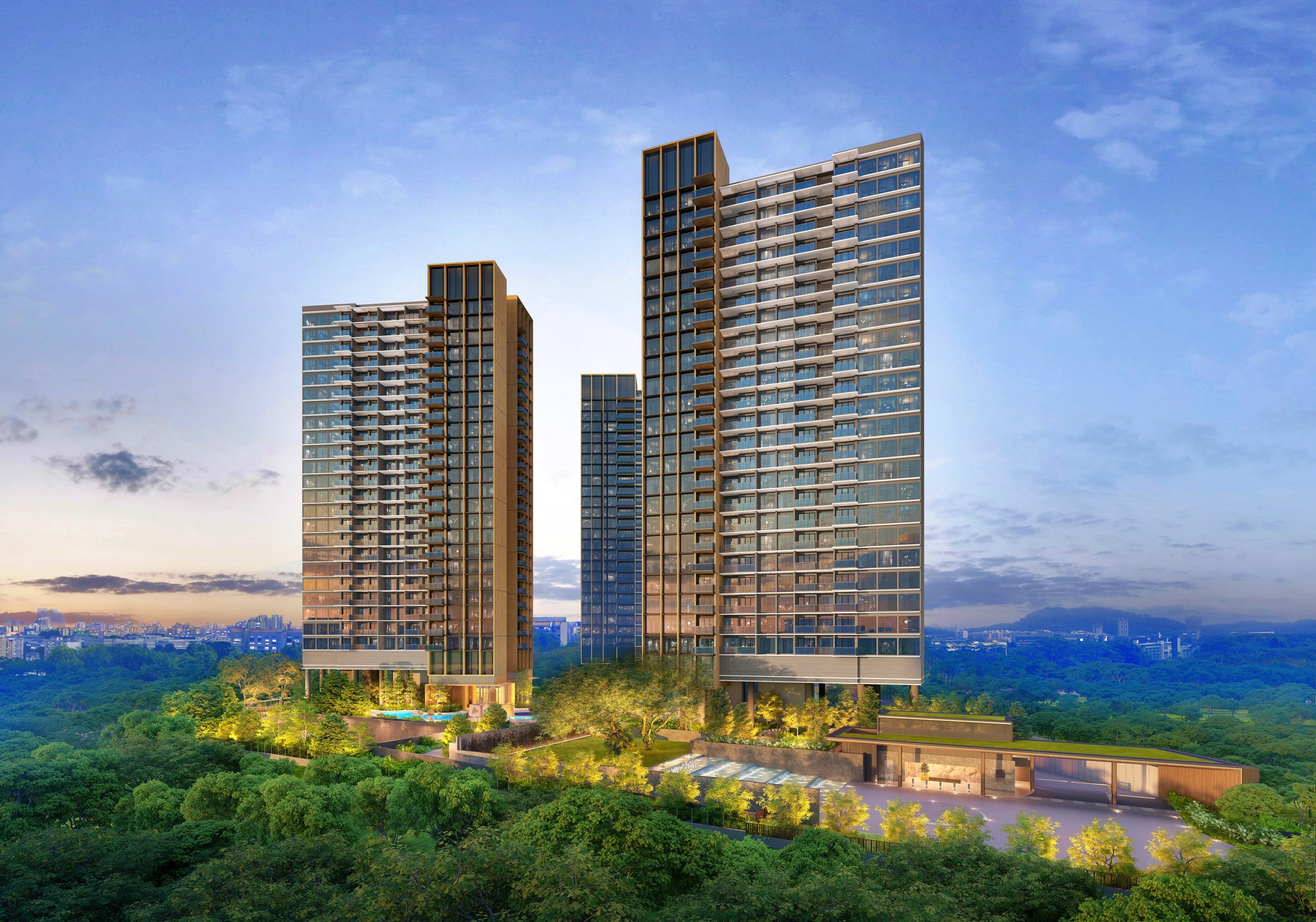 Three residential towers of different heights, featuring a grid-like pattern of windows and balconies, set against a backdrop of a distant cityscape and a lush green forested area. The towers are situated on a landscaped base with a pool and greenery.