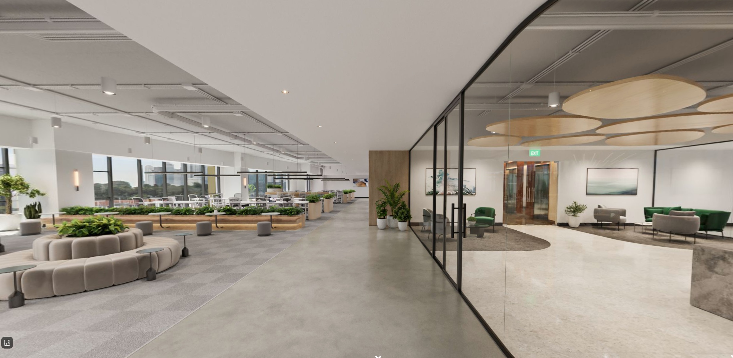 A wide, modern office space with polished concrete floors and high ceilings. A curved, cushioned seating area is in the foreground, leading to a long row of tables and chairs. A glass-walled office with a door is on the right, featuring artwork and seating. Circular, layered wood panels hang from the ceiling in the office space.
