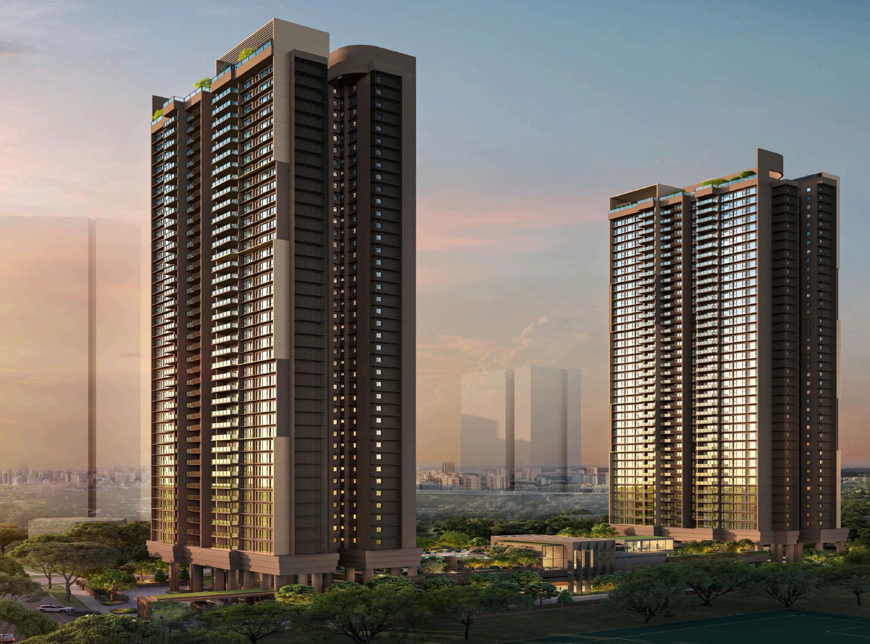 Two Penrith condo buildings stand tall against a sunset sky. The building on the left is taller and wider than the one on the right. Both buildings have a similar modern architectural style with many windows and balconies. Trees and a small structure are visible at the base of the buildings.